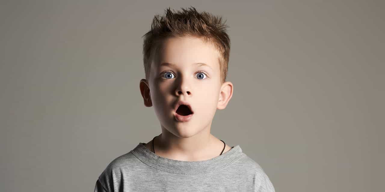 A boy who looks like he is shocked about something he sees